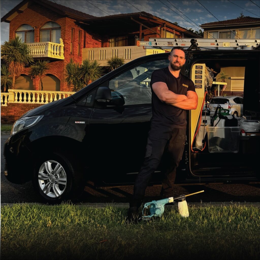 Stark Pest Solutions technician standing beside the fully equipped pest control van at a Sydney residential job